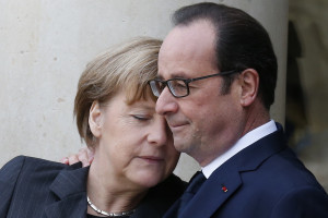 French President Hollande welcomes Germany's Chancellor Merkel as she arrives at the Elysee Palace before the solidarity marchin the streets of Paris